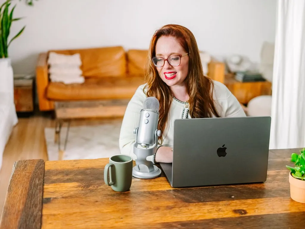 Dr. Monica Rysavy smiling at a podcast microphone